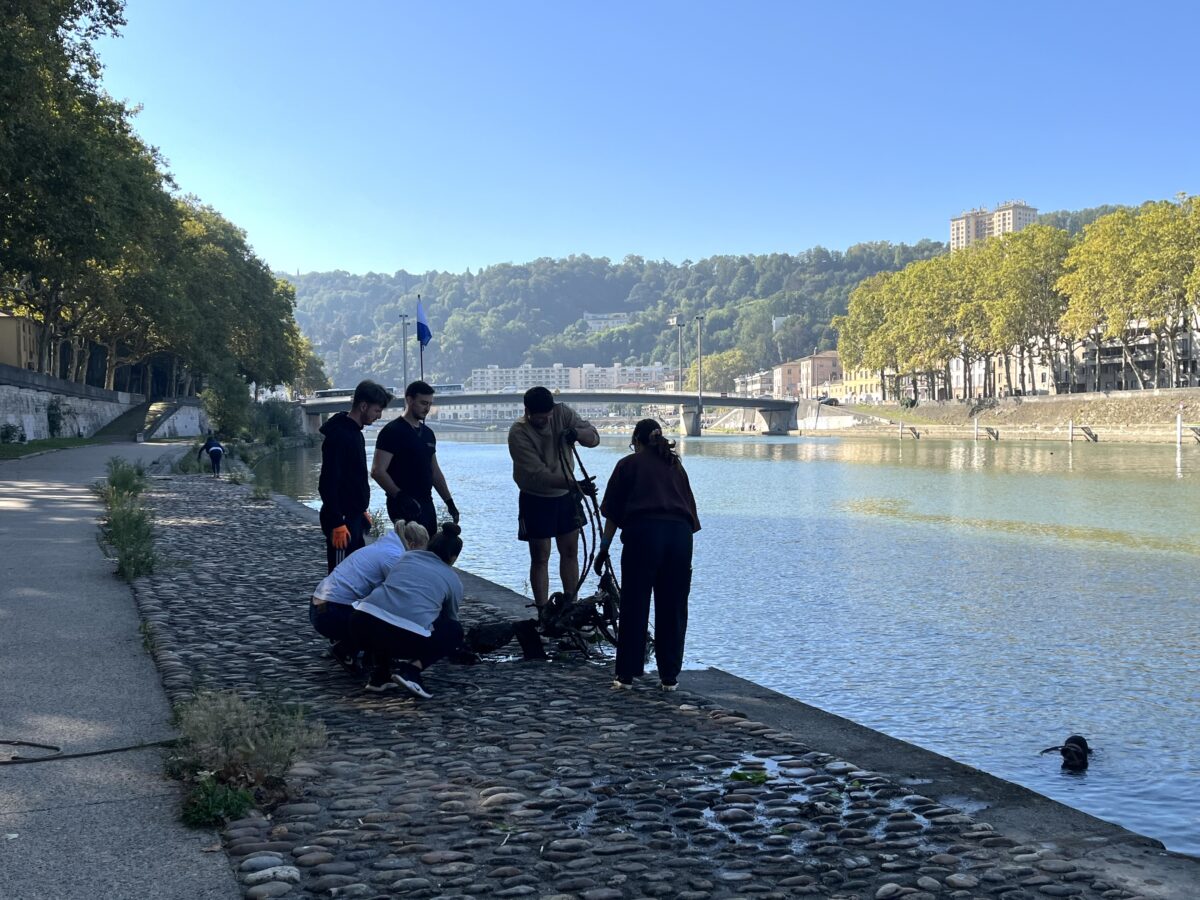 Bénévoles repêchant un scooter de l'eau